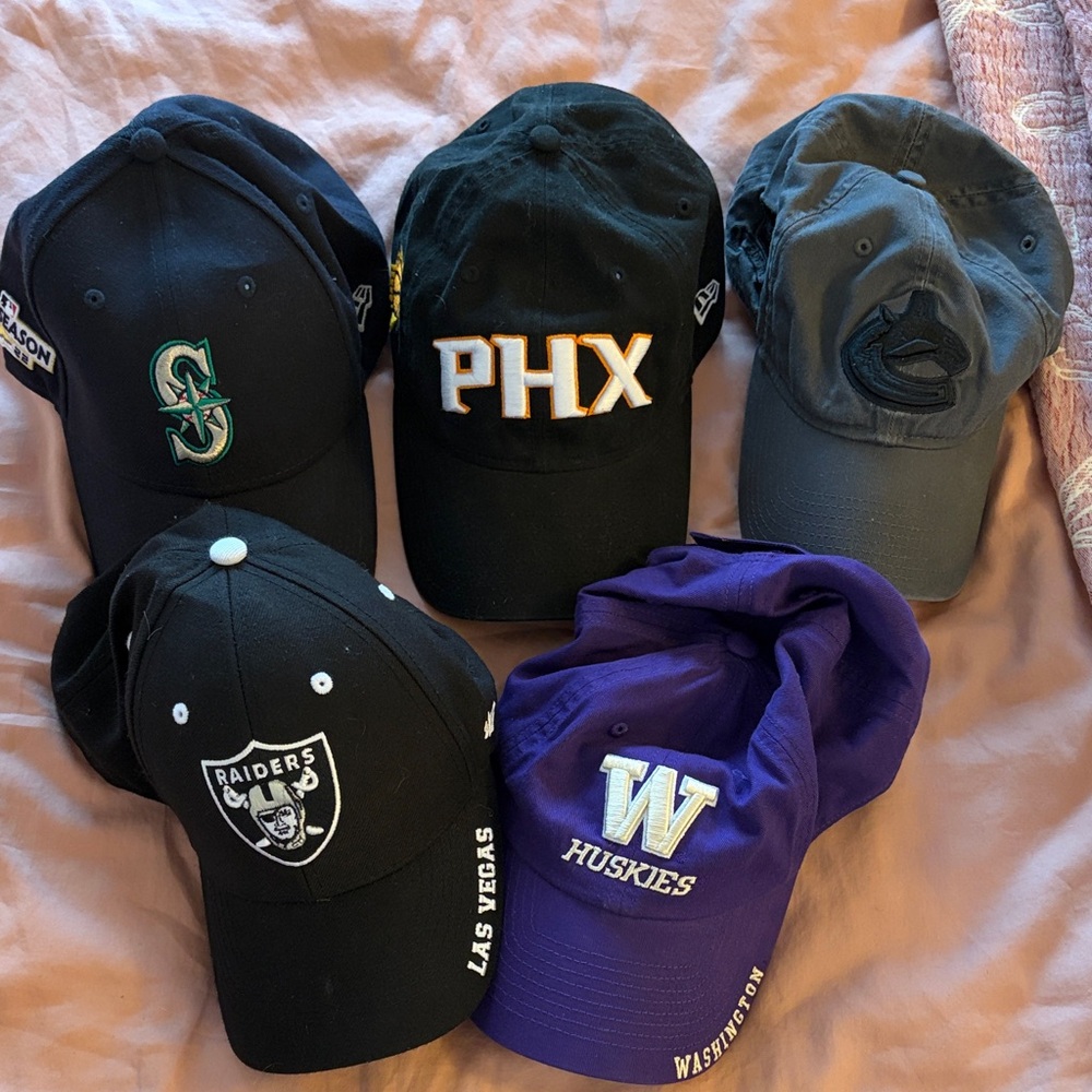 Assortment of sports teams baseball hats